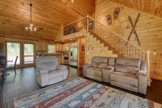 living area featuring dark wood-style flooring, wooden walls, high vaulted ceiling, wood ceiling, and a chandelier