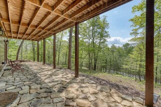 view of patio / terrace with a forest view