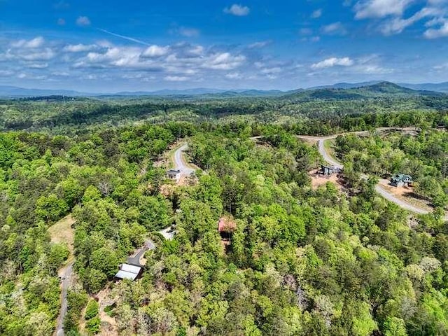 birds eye view of property featuring a view of trees