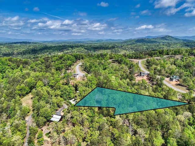 drone / aerial view featuring a forest view