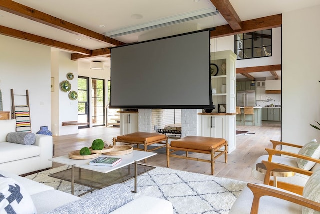 living room featuring beam ceiling and light wood-type flooring