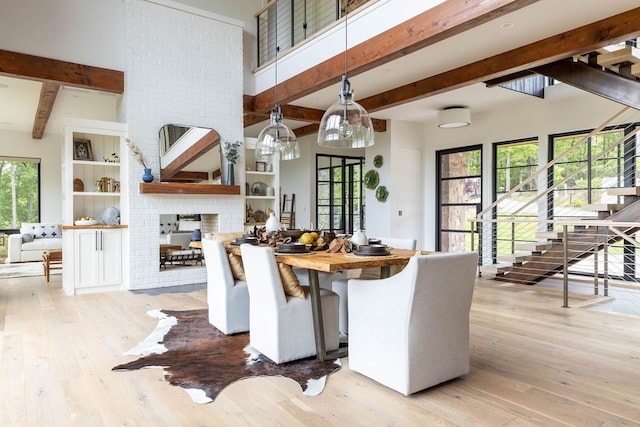 dining space with light hardwood / wood-style floors and built in shelves