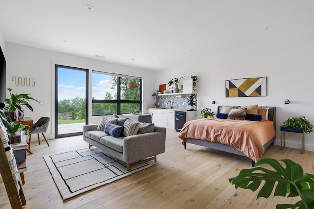 bedroom featuring access to exterior and light hardwood / wood-style floors