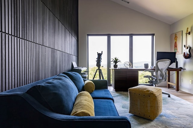 interior space with light wood-type flooring and high vaulted ceiling