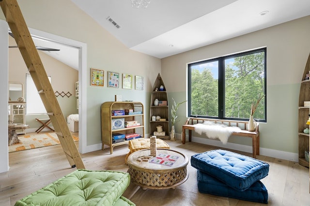 living area with light hardwood / wood-style floors and lofted ceiling