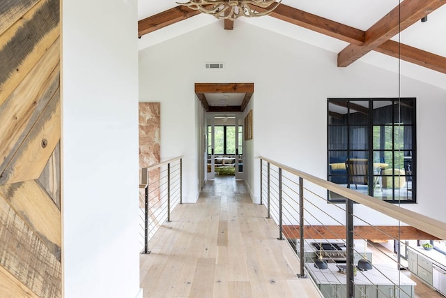 hallway featuring beam ceiling, high vaulted ceiling, and light hardwood / wood-style flooring