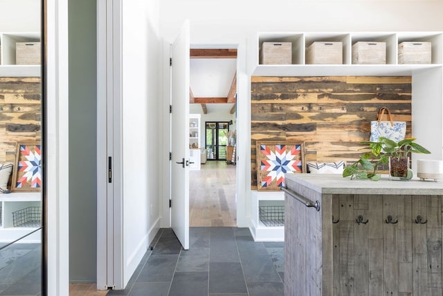 mudroom featuring beamed ceiling, dark hardwood / wood-style floors, and wooden walls