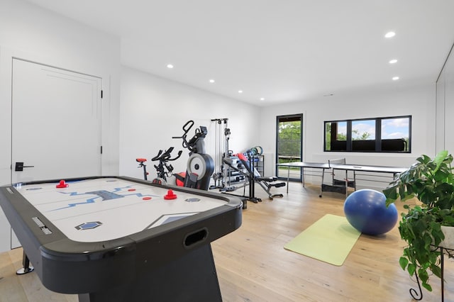 game room with light hardwood / wood-style floors