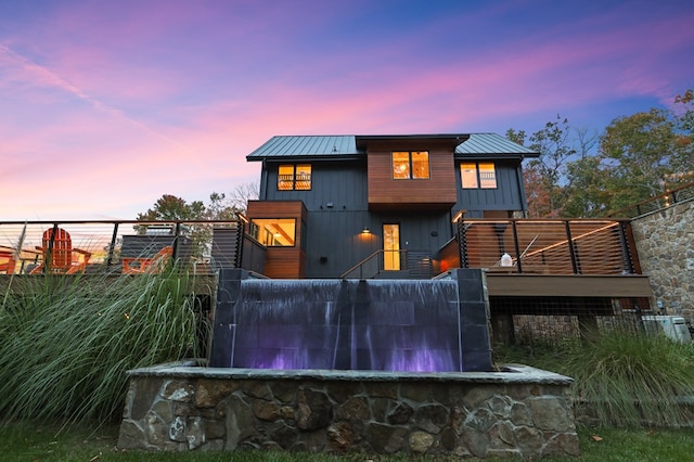 view of back house at dusk