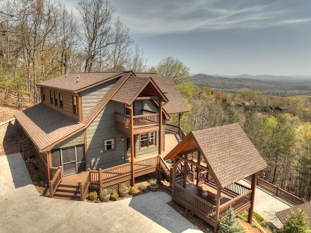 exterior space featuring a mountain view and a balcony