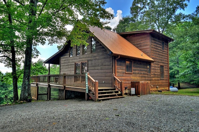 rear view of property featuring a deck