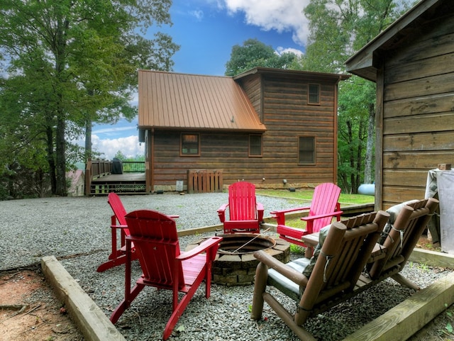 view of patio with a wooden deck and a fire pit