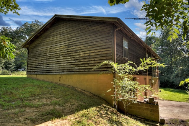 view of property exterior with a lawn