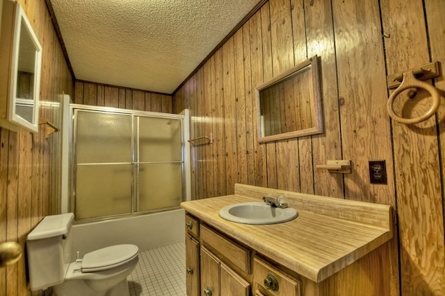 full bathroom with toilet, combined bath / shower with glass door, a textured ceiling, vanity, and tile patterned floors