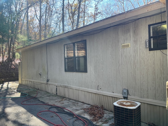 view of side of property featuring central AC