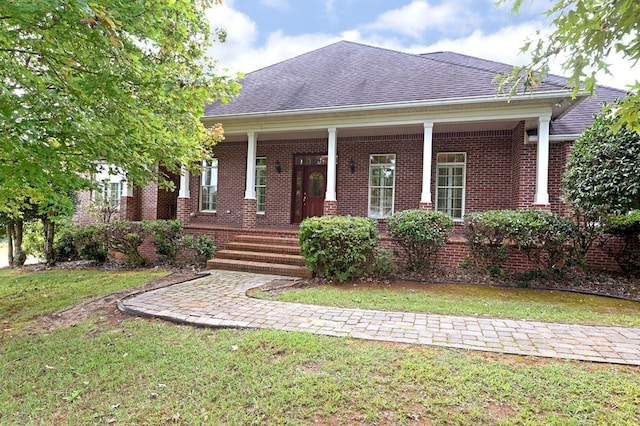 1507 Cedar View Ln, Hiawassee, GA 30546 - view of front of house with covered porch, brick siding, roof with shingles, and a front lawn