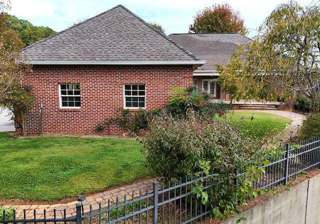 view of side of property with a yard