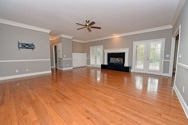 unfurnished living room with crown molding, french doors, ceiling fan, and light hardwood / wood-style flooring