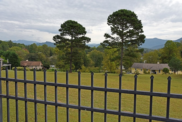 surrounding community featuring a lawn and a mountain view