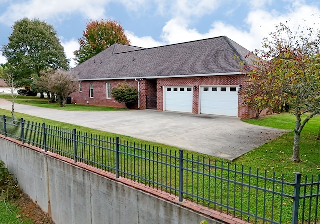 1507 Cedar View Ln, Hiawassee, GA 30546 - view of home's exterior with roof with shingles, a lawn, concrete driveway, and brick siding