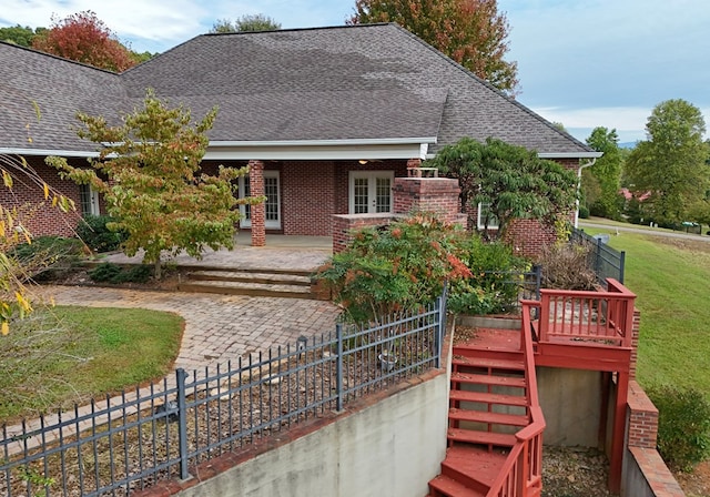 1507 Cedar View Ln, Hiawassee, GA 30546 - exterior space featuring fence, a shingled roof, brick siding, a front yard, and french doors