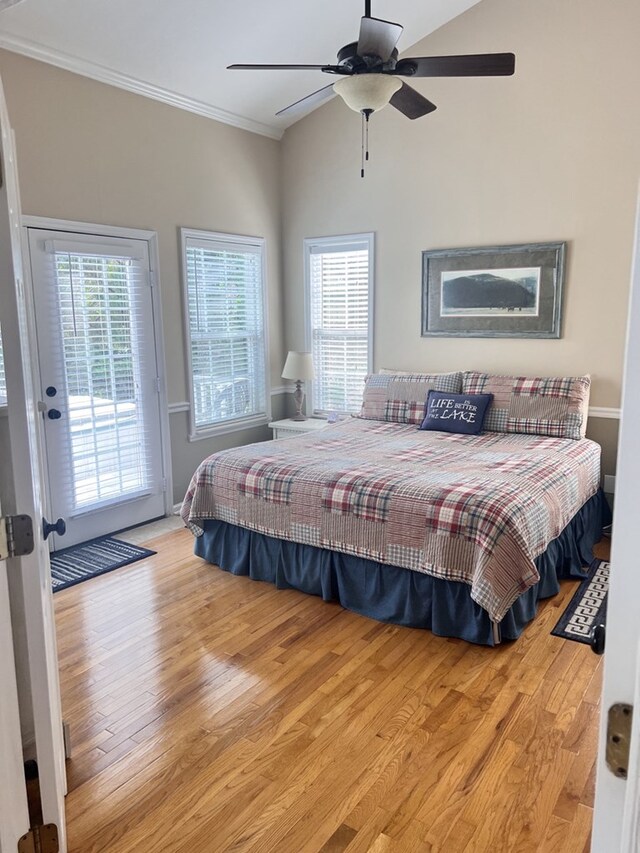 bedroom with access to exterior, ceiling fan, multiple windows, and light hardwood / wood-style floors