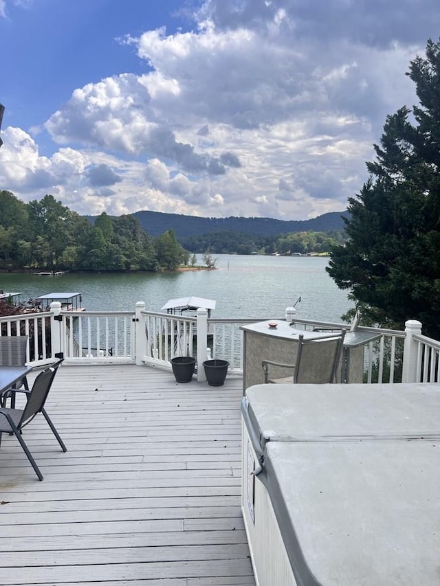 exterior space featuring a deck with water view