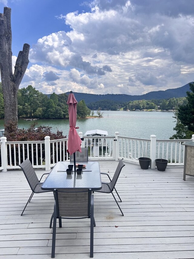 deck with a water and mountain view