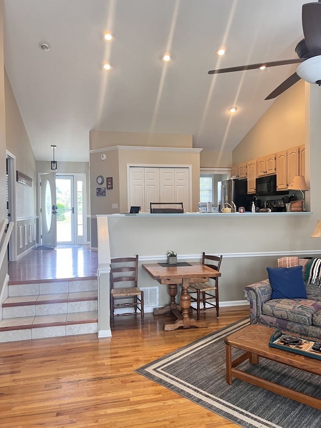 living room featuring high vaulted ceiling, wood-type flooring, and ceiling fan