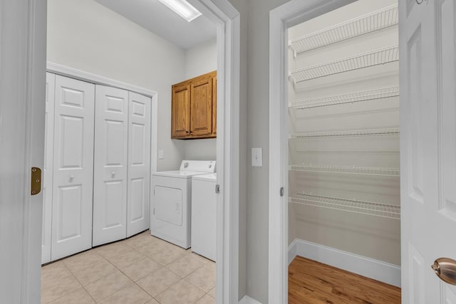 1647-8H Lakeview Dr, Young Harris, GA 30582 - washroom with baseboards, light tile patterned flooring, cabinet space, and washer and dryer