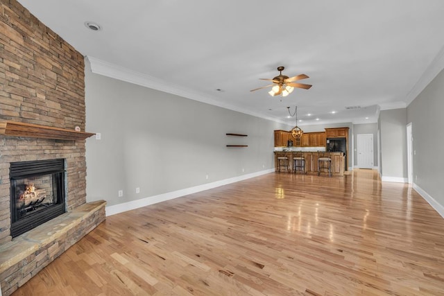 1647-8H Lakeview Dr, Young Harris, GA 30582 - unfurnished living room featuring ceiling fan, light wood-style floors, a stone fireplace, baseboards, and ornamental molding