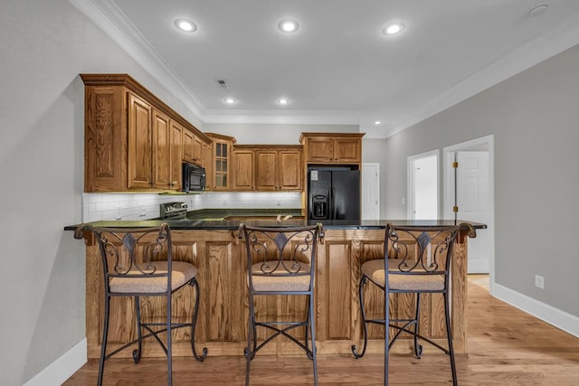 1647-8H Lakeview Dr, Young Harris, GA 30582 - kitchen with crown molding, brown cabinets, black appliances, and dark countertops