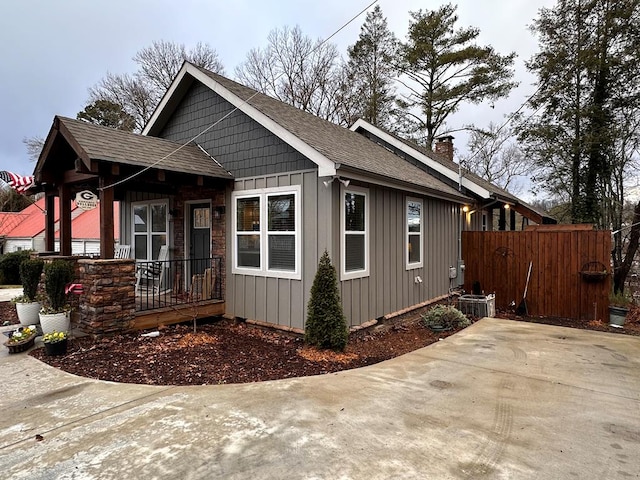 610 E Second St, Blue Ridge, GA 30513 - view of front of home featuring board and batten siding, a shingled roof, and a chimney
