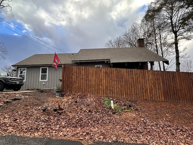 610 E Second St, Blue Ridge, GA 30513 - view of home's exterior featuring board and batten siding, roof with shingles, and a chimney