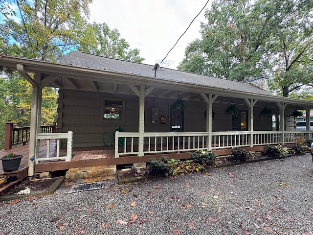 view of front of property featuring a porch and a chimney
