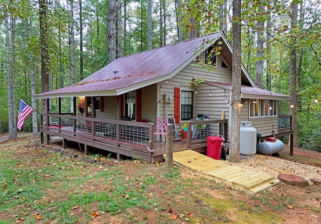 view of front facade featuring metal roof and a deck