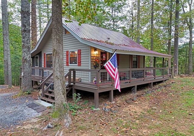 view of front of property featuring a deck and metal roof