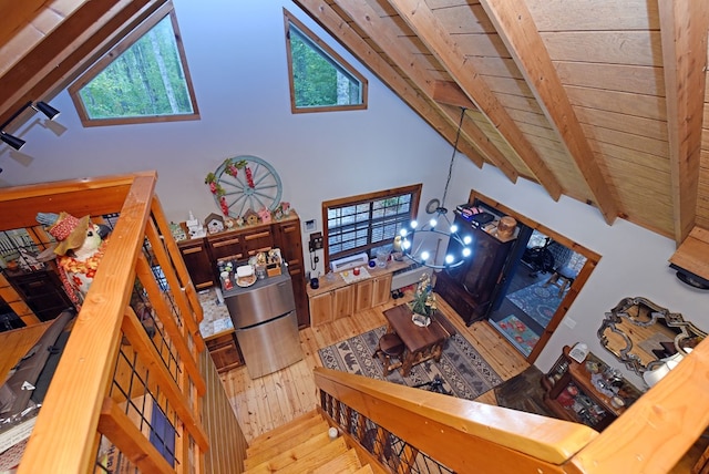living room featuring wood ceiling, a healthy amount of sunlight, hardwood / wood-style floors, and beamed ceiling