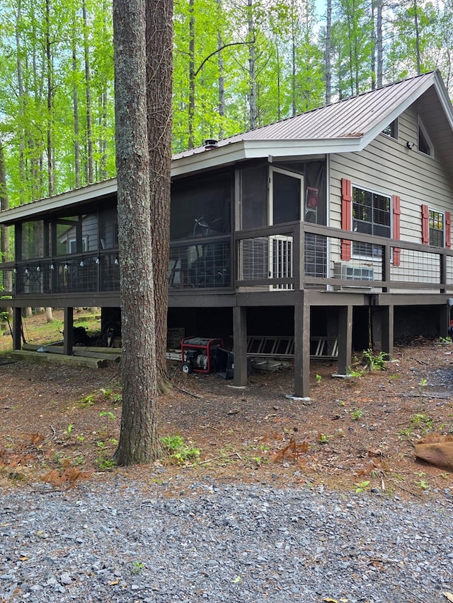 view of front of property with a sunroom and metal roof