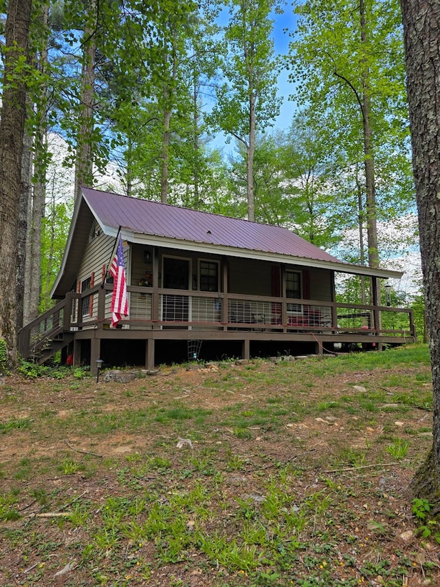back of property featuring metal roof