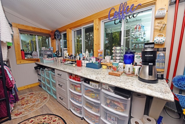 kitchen with lofted ceiling and light wood-style floors