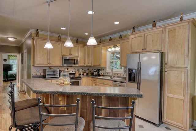 kitchen featuring stainless steel appliances, sink, light brown cabinetry, and a breakfast bar