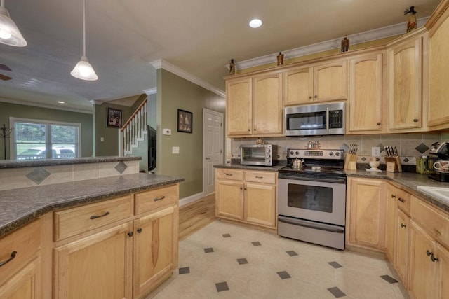 kitchen with tasteful backsplash, appliances with stainless steel finishes, light brown cabinetry, and hanging light fixtures