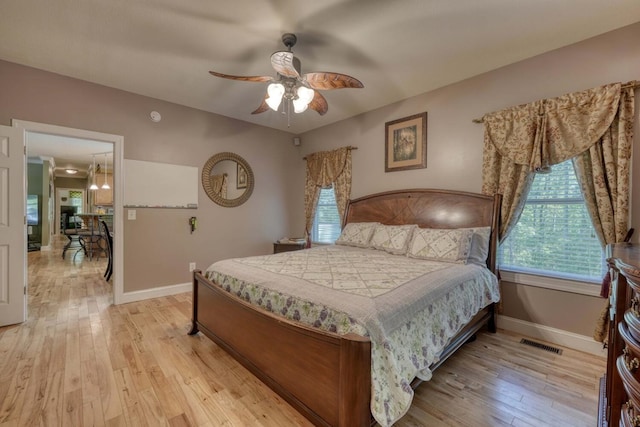 bedroom with light hardwood / wood-style flooring and ceiling fan