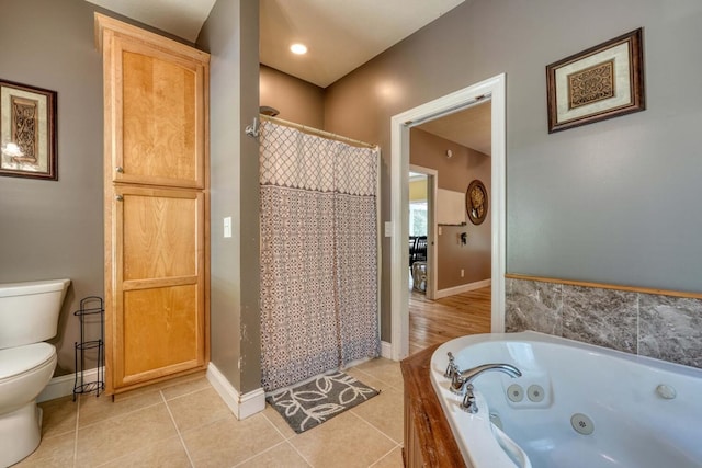 bathroom featuring tile patterned flooring, shower with separate bathtub, and toilet