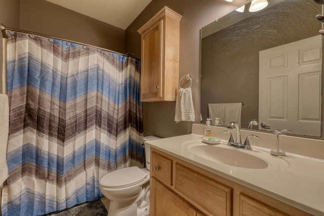 bathroom with vanity, a shower with shower curtain, and toilet