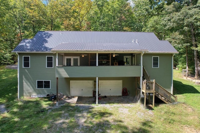 back of house with a garage and a yard