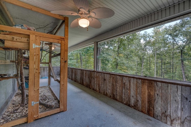 unfurnished sunroom with ceiling fan