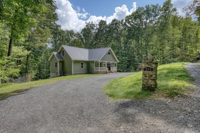 view of front of property featuring covered porch and a front lawn