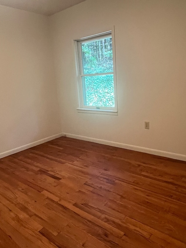 empty room featuring dark hardwood / wood-style flooring